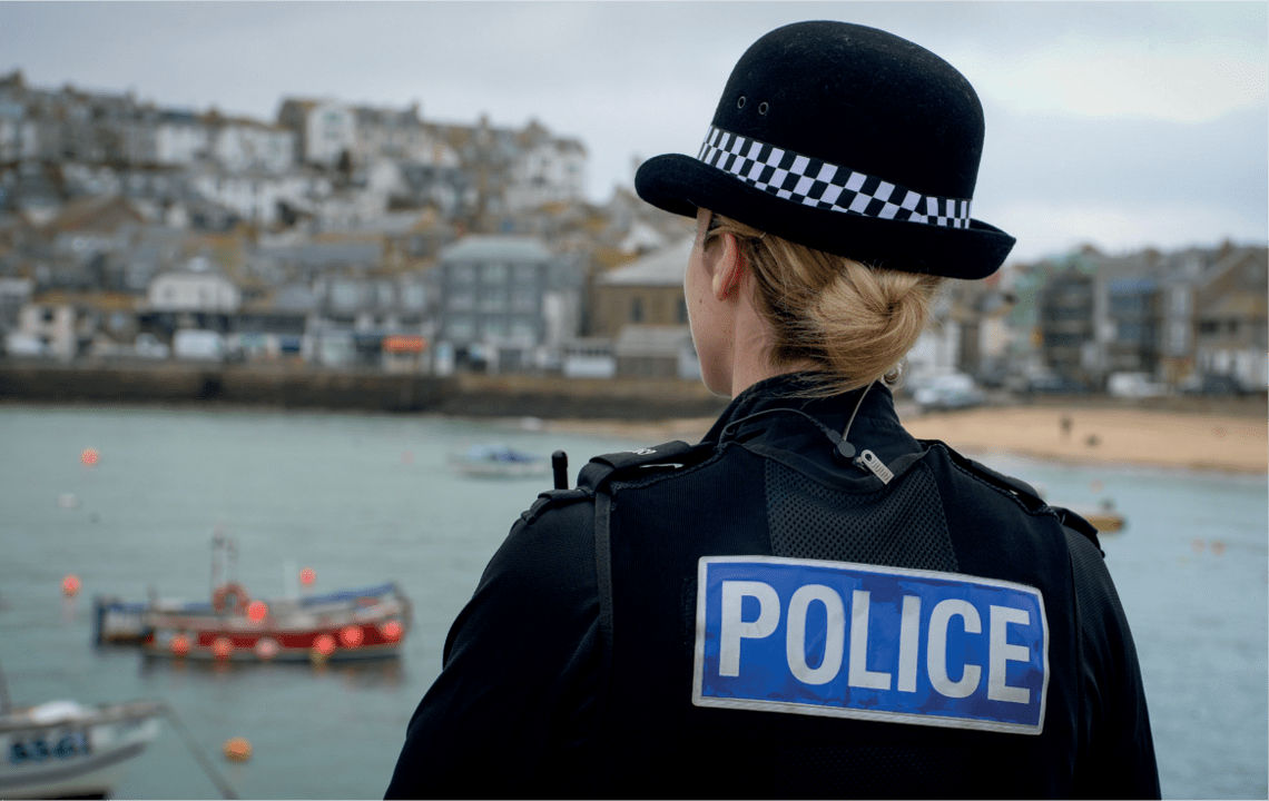 Female officer back of head looking across the bay