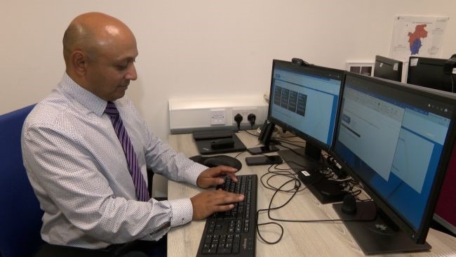 Detective Inspector Praveen Naidoo sat at his desk