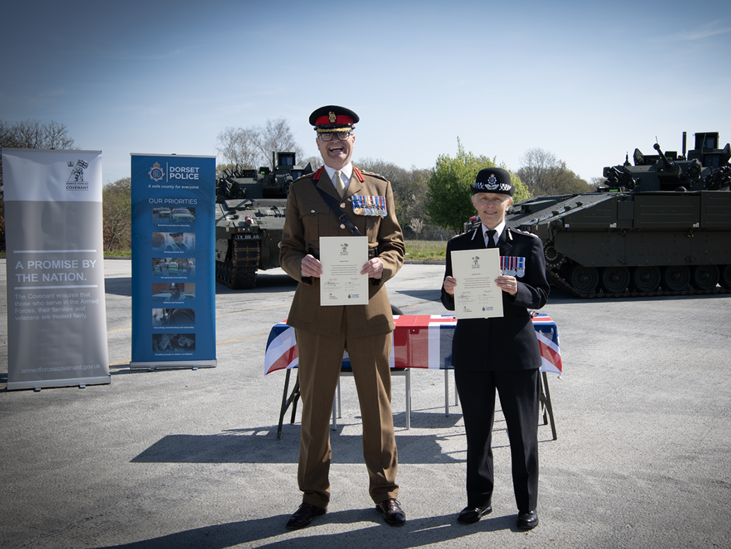 Colonel John Godfrey and Chief Constable Amanda Pearson smiling with signed covenant 