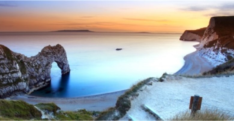 View of beach and coastline, bright blue sea and calm water