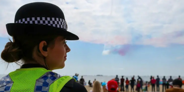 Female officer looking over the beach