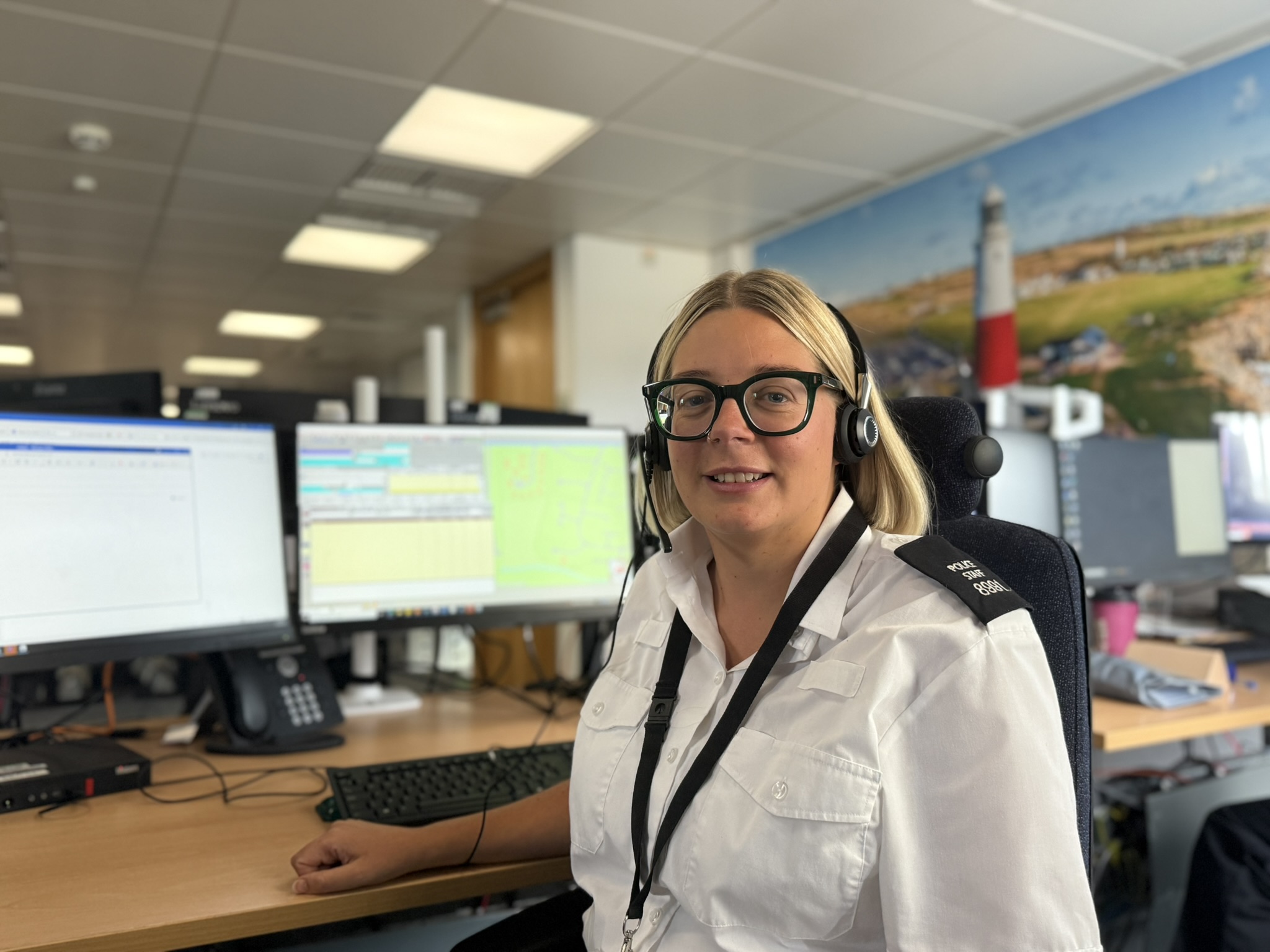 Call handler with headset looking at screen