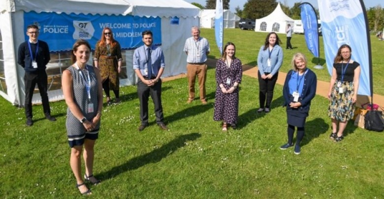 Smiling male police staff member sitting at desk
