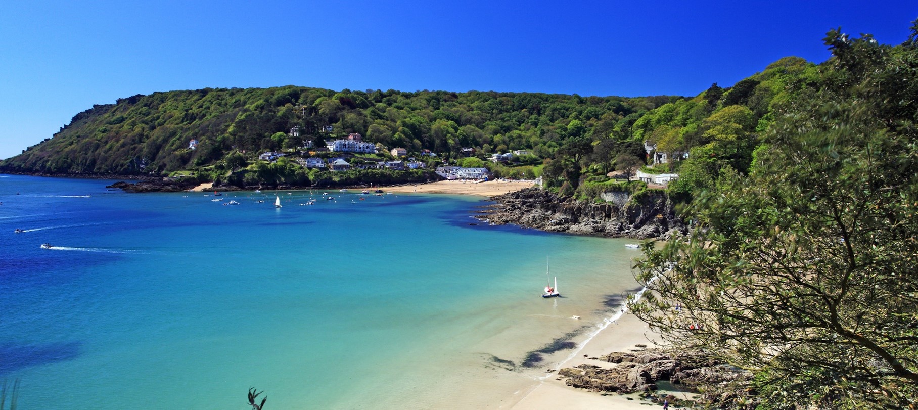 View of beach and coastline, bright blue sea and calm water